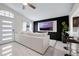 Bright living room features a large sofa, modern TV, and updated lighting, ideal for relaxation at 5729 Norman H Cutson Dr, Orlando, FL 32821