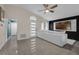 Light-filled living room featuring a plush white sectional, modern accent wall, and stylish wood-look tile floors at 5729 Norman H Cutson Dr, Orlando, FL 32821