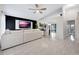 Open-concept living room with a ceiling fan, white sectional sofa, and modern accent wall is bright and inviting at 5729 Norman H Cutson Dr, Orlando, FL 32821