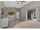 Comfortable bedroom featuring tile floors, a ceiling fan, and access to a patio with natural light at 5729 Norman H Cutson Dr, Orlando, FL 32821