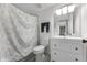 Well-lit bathroom showcasing a modern vanity, toilet, and patterned shower curtain at 658 Lake Villas Dr, Altamonte Springs, FL 32701