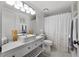 Bright bathroom featuring a vessel sink, neutral-toned walls, and a decorative shower curtain at 658 Lake Villas Dr, Altamonte Springs, FL 32701