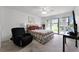 Cozy bedroom with a comfortable bed, ceiling fan, and sliding glass doors to the outside at 658 Lake Villas Dr, Altamonte Springs, FL 32701