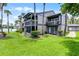 Stunning exterior view of the building with lush green lawn and lake view at 658 Lake Villas Dr, Altamonte Springs, FL 32701