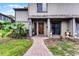 Inviting townhome front entrance with a brick path and a beautifully carved wooden door at 658 Lake Villas Dr, Altamonte Springs, FL 32701