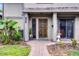 Inviting townhome front entrance with a brick path and a beautifully carved wooden door at 658 Lake Villas Dr, Altamonte Springs, FL 32701