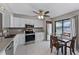 Bright kitchen with white cabinets, stainless steel appliances, and an eat-in dining area at 658 Lake Villas Dr, Altamonte Springs, FL 32701