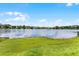 Scenic lake view with lush green lawn and the reflections of clouds in the background at 658 Lake Villas Dr, Altamonte Springs, FL 32701