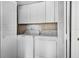 Convenient laundry room with a washer and dryer hidden behind folding doors at 658 Lake Villas Dr, Altamonte Springs, FL 32701