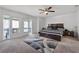 Serene main bedroom with a cozy bed, ceiling fan, and access to an outdoor balcony at 658 Lake Villas Dr, Altamonte Springs, FL 32701