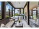 Relaxing sunroom with neutral furnishings and views of the surrounding foliage at 658 Lake Villas Dr, Altamonte Springs, FL 32701