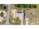 Aerial view of the property featuring a well-manicured lawn and metal roof at 7135 Sw 129Th St, Ocala, FL 34473