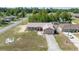 Aerial view of a single-story home with a spacious yard, driveway, and neighborhood surroundings at 7135 Sw 129Th St, Ocala, FL 34473