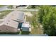 Aerial view of home with a metal roof and solar panels with covered patio at 7135 Sw 129Th St, Ocala, FL 34473
