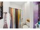 This bathroom features a tub with shower and colorful striped shower curtain at 7135 Sw 129Th St, Ocala, FL 34473