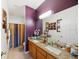 Bathroom featuring granite counters, double sinks and a full tub and shower at 7135 Sw 129Th St, Ocala, FL 34473