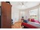 Bedroom with wood floors, natural light, closet, and comfortable furnishings at 7135 Sw 129Th St, Ocala, FL 34473