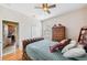 Well-lit bedroom with wood floors, ceiling fan, and comfortable furnishings for relaxing at 7135 Sw 129Th St, Ocala, FL 34473