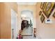 Welcoming entryway featuring a light-filled foyer, neutral walls adorned with decorative art, and a glimpse into the living area at 7135 Sw 129Th St, Ocala, FL 34473