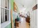 View of hallway decorated with art, vintage furniture, and white ceiling fans at 7135 Sw 129Th St, Ocala, FL 34473