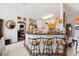 Charming kitchen featuring a breakfast bar with seating and a view into the living room at 7135 Sw 129Th St, Ocala, FL 34473