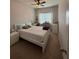 Bedroom with white bed frame, matching nightstands, desk with music keyboard, and natural light at 7629 Ripplepointe Way, Windermere, FL 34786