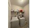 Laundry room featuring washer and dryer hookups, shelving, and ample storage space at 7629 Ripplepointe Way, Windermere, FL 34786