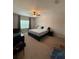 Cozy primary bedroom with carpet, a ceiling fan, and a bright window at 7629 Ripplepointe Way, Windermere, FL 34786