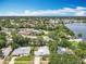 Expansive aerial view of a residential neighborhood featuring lush landscaping and a serene lake at 7679 Bent Bow Trl, Winter Park, FL 32792