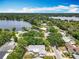 Aerial view of a home surrounded by a lush, established neighborhood and beautiful lakes at 7679 Bent Bow Trl, Winter Park, FL 32792