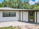 Backyard view of the exterior of the home with a paver patio and lawn at 7679 Bent Bow Trl, Winter Park, FL 32792