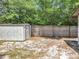 A backyard with a storage shed and a wooden fence, offering practical outdoor space at 7679 Bent Bow Trl, Winter Park, FL 32792