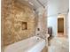 A cozy shower-tub combo with tiled walls, located next to the bedroom at 7679 Bent Bow Trl, Winter Park, FL 32792