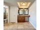 Updated bathroom with a large granite vanity, framed mirrors, and tiled floors at 7679 Bent Bow Trl, Winter Park, FL 32792