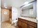 Well-lit bathroom boasts granite counters, wood cabinets, and a shower-tub combo with tiled walls at 7679 Bent Bow Trl, Winter Park, FL 32792