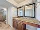 Bathroom with granite vanity, framed mirrors, and tiled floors at 7679 Bent Bow Trl, Winter Park, FL 32792