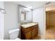 This bathroom features a granite countertop and a decorative framed mirror at 7679 Bent Bow Trl, Winter Park, FL 32792