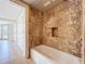 A cozy shower-tub combo with tiled walls, located next to the bedroom at 7679 Bent Bow Trl, Winter Park, FL 32792