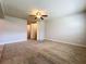 Bedroom showing ceiling fan and an open doorway at 7679 Bent Bow Trl, Winter Park, FL 32792