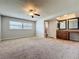 Bedroom displaying a ceiling fan, a window, and an attached bathroom at 7679 Bent Bow Trl, Winter Park, FL 32792