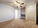 A cozy bedroom featuring carpet floors, a ceiling fan, and a walk-in closet at 7679 Bent Bow Trl, Winter Park, FL 32792