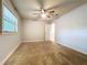 Bedroom showing ceiling fan, window with blinds, and neutral paint at 7679 Bent Bow Trl, Winter Park, FL 32792