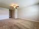 Spacious bedroom with neutral carpet, paint and trim, and large closets at 7679 Bent Bow Trl, Winter Park, FL 32792
