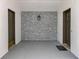 Enclosed carport with white walls and a decorative stone accent wall at 7679 Bent Bow Trl, Winter Park, FL 32792