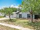Inviting single-story home with stone accents, green lawn, and mature trees, offering great curb appeal at 7679 Bent Bow Trl, Winter Park, FL 32792