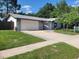 Charming single-story home featuring a well-maintained lawn and a two-car garage at 7679 Bent Bow Trl, Winter Park, FL 32792