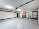 Spacious two car garage features a refrigerator, storage racks, and shelving at 7679 Bent Bow Trl, Winter Park, FL 32792