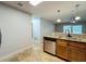 Bright kitchen area with stainless steel appliances and a seamless transition to living area at 7679 Bent Bow Trl, Winter Park, FL 32792