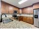 Well-equipped kitchen featuring granite countertops and stainless steel appliances at 7679 Bent Bow Trl, Winter Park, FL 32792