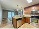 Open kitchen design featuring stainless steel appliances and granite countertops at 7679 Bent Bow Trl, Winter Park, FL 32792